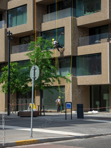Two window washers working on modern building