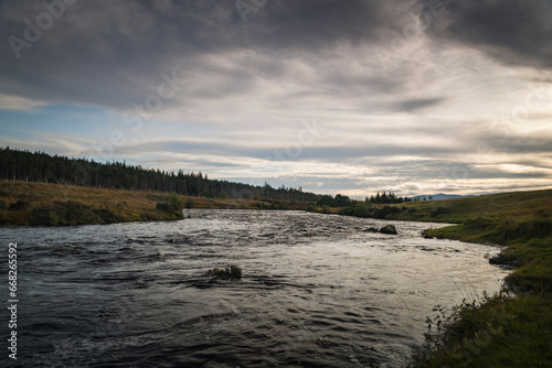 An autumnal dusk HDR image of the River Naver  known as a salmon river  and the Naver Forest in Strathnaver  Sutherland  Scotland