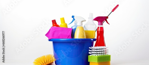 Cleaning supplies in plastic bucket on white background