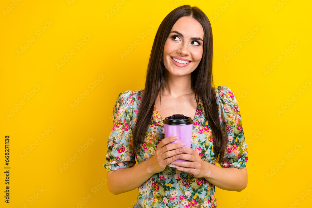 Photo of nice pretty girl with brunette hair dressed flower print blouse hold latte look empty space isolated on yellow color background Photo of nice pretty girl with brunette hair dressed flower print blouse hold latte look empty space isolated on yellow color background