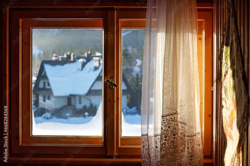 Beautiful view from window on winter village with  snow in sunny day. Enjoying winter weather - obrazy, fototapety, plakaty 