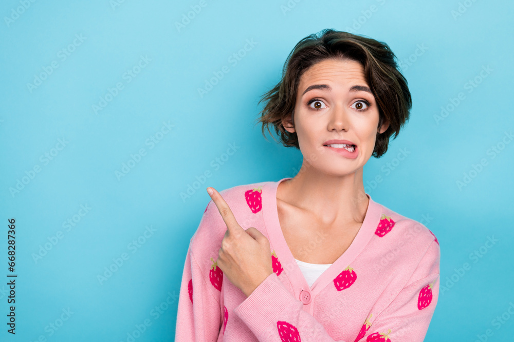 Photo of embarrassed glamour girl wear pink clothes arm direct empty space interesting news banner ad isolated on blue color background Photo of embarrassed glamour girl wear pink clothes arm direct empty space interesting news banner ad isolated on blue color background