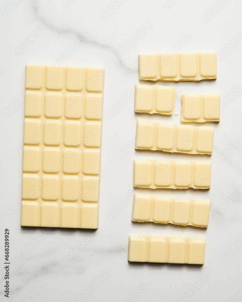 White chocolate bar on white marble background. 