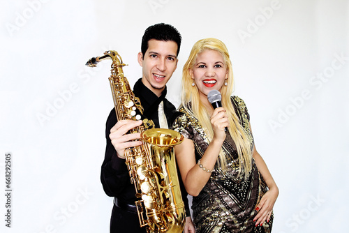 Canvas Print Blonde woman singer and white man saxophonist posing for the camera