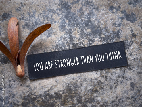 Motivational and inspirational wording. YOU ARE STRONGER THAN YOU THINK written on a paper. With blurred styled background.