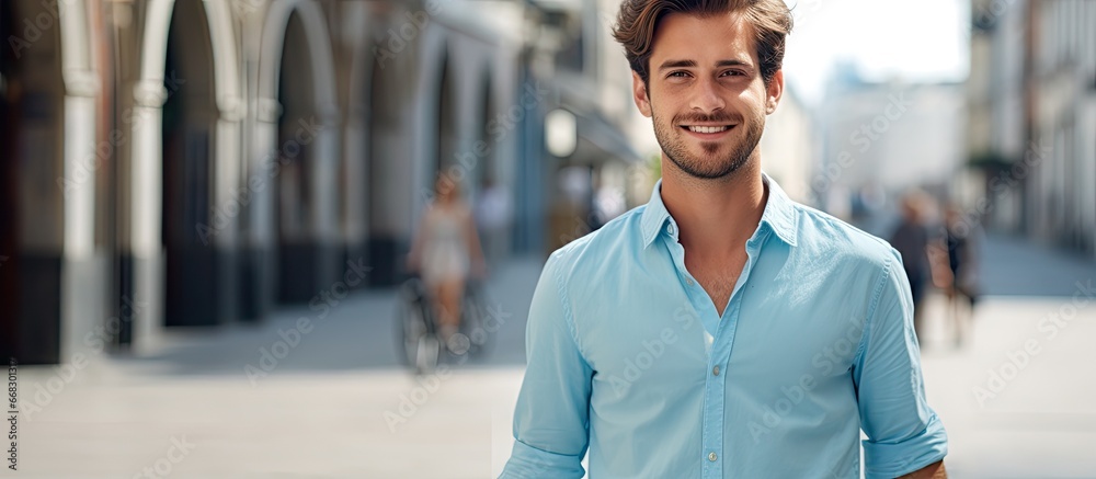 Young European man in blue shirt strolling through the city Young European man in blue shirt strolling through the city