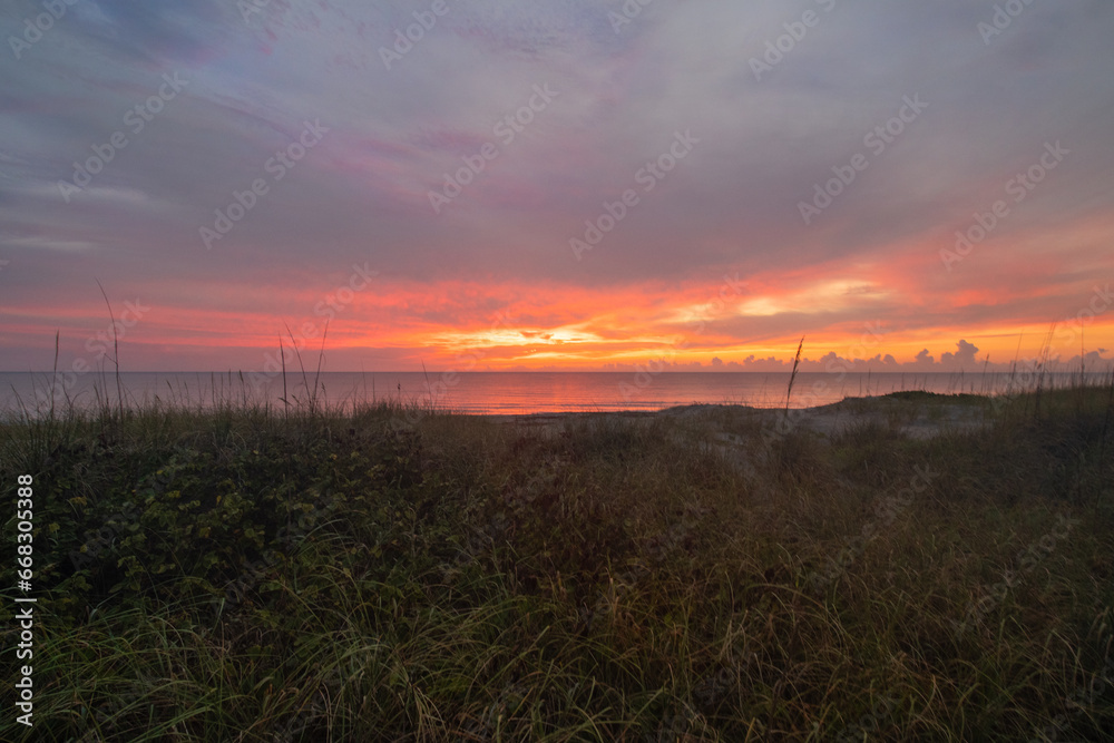 sunrise over beach dunes