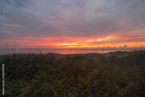 sunrise over beach dunes