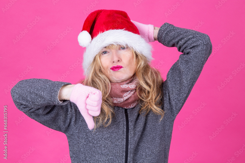 woman with santa claus cap and thumbs down. hate christmas woman with santa claus cap and thumbs down. hate christmas