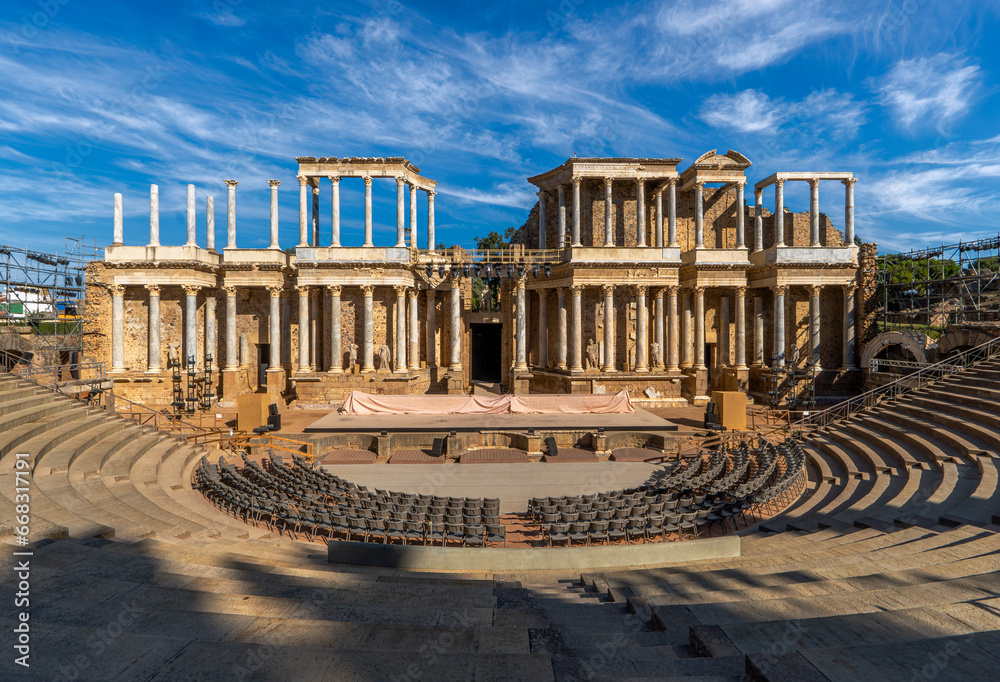 Fototapeta premium Roman Theater of Mérida with the scaffolding, spotlights, stage and chairs placed under the stands prepared for the Mérida International Classical Theater Festival. Classical Roman columns and statues