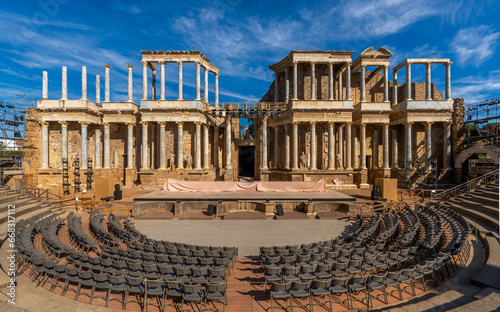 Mérida Roman theater from behind with a view of the chairs, granite steps and the stage scaenae frons of classical Roman columns and statues for the Merida International Classical Theater Festival. photo