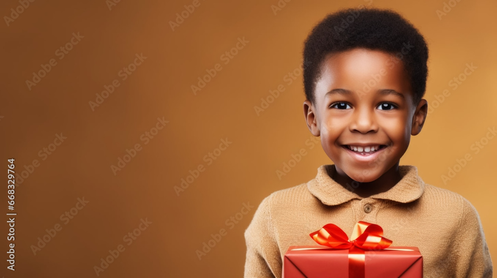 Black african american child with a Christmas present during Christmas time. Little child recieving a Christmas present. Happy child smiling with a present. Christmas background. Black african american child with a Christmas present during Christmas time. Little child recieving a Christmas present. Happy child smiling with a present. Christmas background.