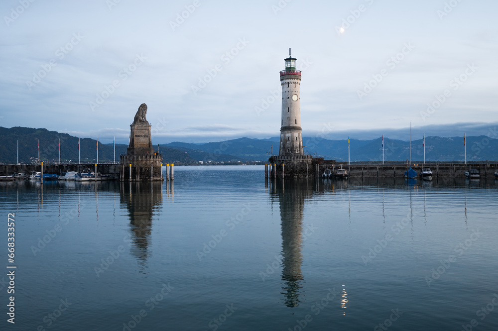 The well-known harbour entrance with its Bavarian lion and white lighthouse is set, Alps and Lake Constance, lindau