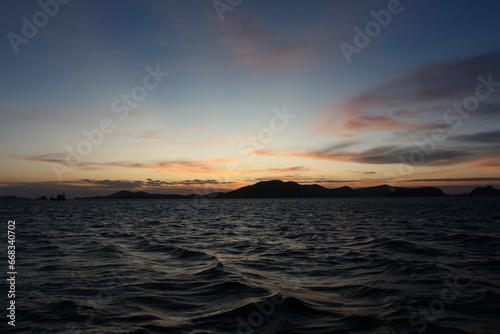 Sea on a winter morning with strong winds and the rays of the morning sun on the horizon.