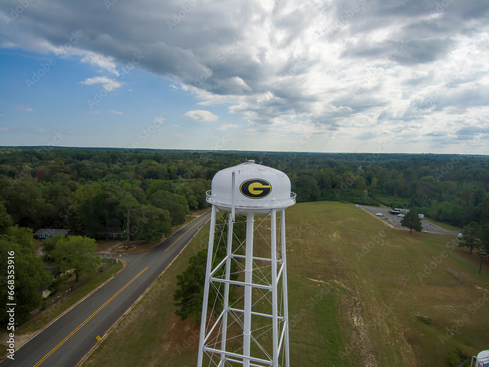 aerial shot of a tall white water tower with the Grambling State