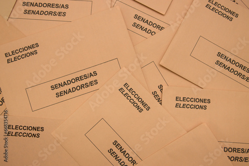 Image from above of a table full of electoral envelopes for the senate in Spain