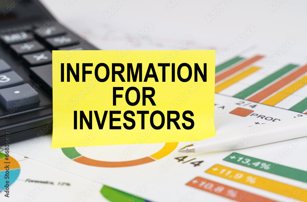 Naklejka premium On business reports there is a calculator and a sign with the inscription - Information for investors