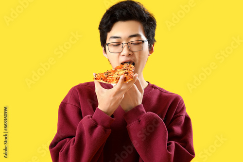 Young Asian man eating tast...
