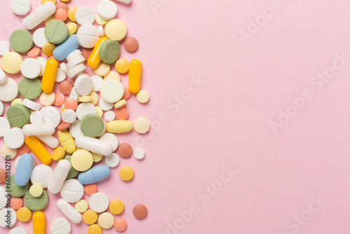 Different medical pills and capsules on color background, top view © Liami
