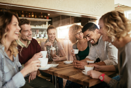 Smiling group of diverse young friends in a cafe