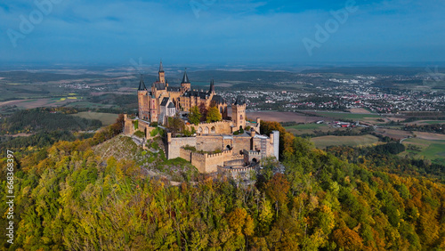 Aerial drone view of medieval Hohenzollern castle on top of hill in autumn  Baden-Wurttemberg  Germany.