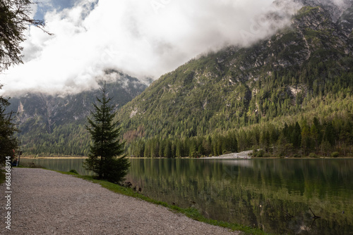 Lago di Dobbiaco surrounded by hills and trees