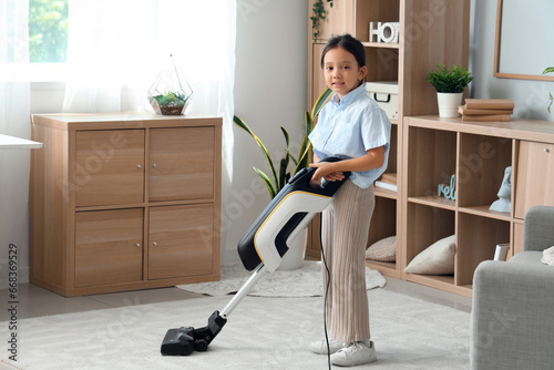 Cute little girl vacuuming ...