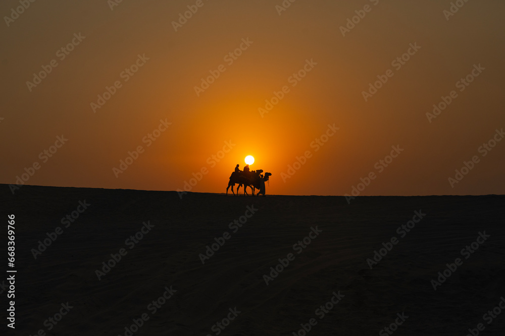 Camel Caravan at Sunset Time in the Doha Desert Photo, Doha Qatar Camel Caravan at Sunset Time in the Doha Desert Photo, Doha Qatar