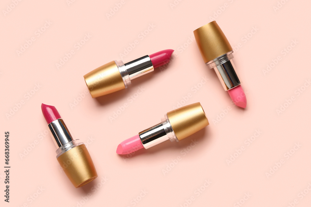 Obraz premium Different bright lipsticks on pink background