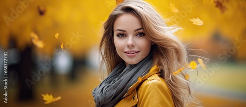 Young woman surrounded by autumn foliage
