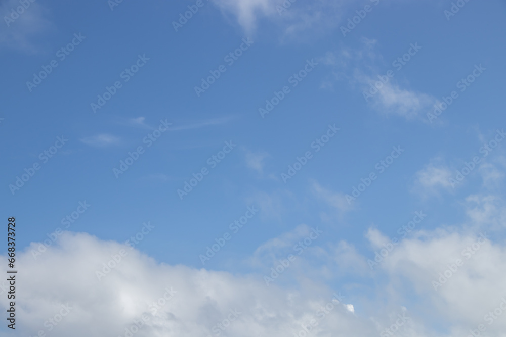 White fluffy clouds against a blue sky background
