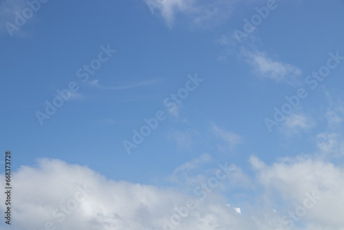 Fototapeta Naklejka Na Ścianę i Meble -  White fluffy clouds against a blue sky background