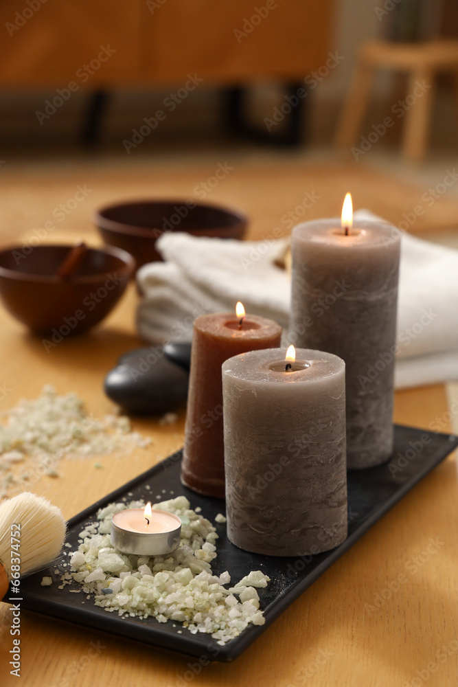 Burning candles with sea salt on table in spa salon, closeup Burning candles with sea salt on table in spa salon, closeup