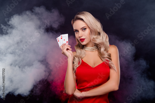 Photo of glossy fancy lady wear sexy dress rising two red aces playing cards isolated black color background