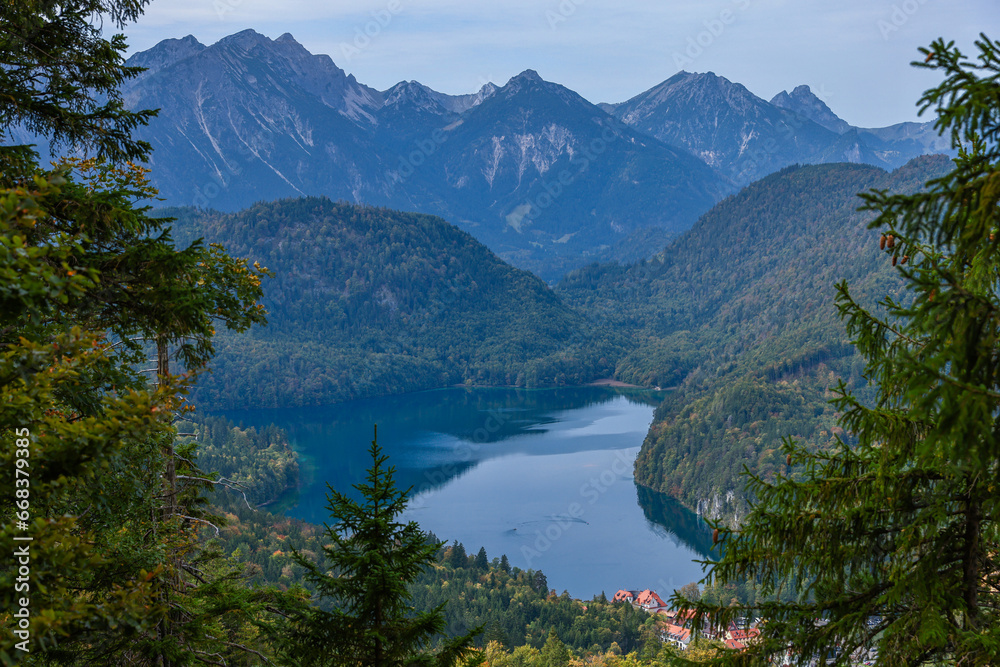 Turquoise lake in mountains Bavarian Alps on foggy morning. Ski resort in auttumn.