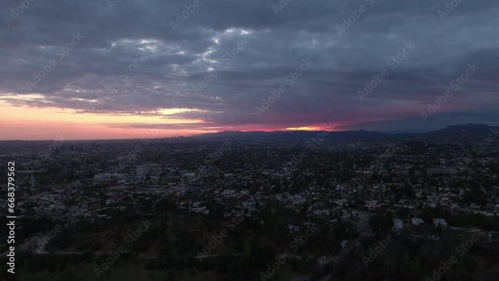 Aerial Panning Shot Of Houses In Neighborhood Near Mountains Against Cloudy Sky At Sunset - Los Angeles, California Aerial Panning Shot Of Houses In Neighborhood Near Mountains Against Cloudy Sky At Sunset - Los Angeles, California