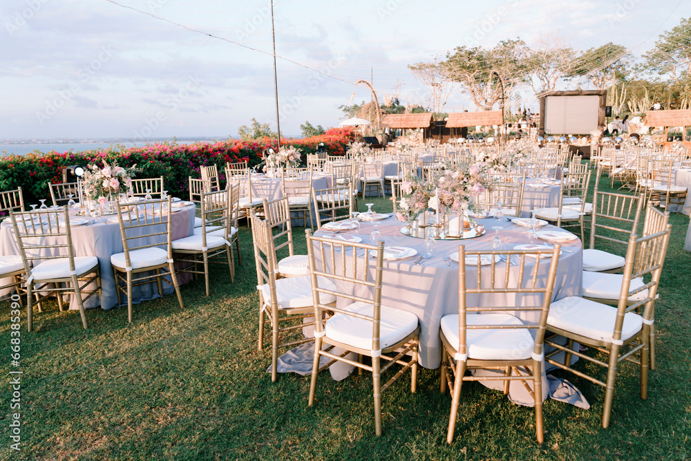 elegantly decorated table at a wedding reception with beautiful sunset