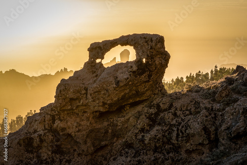 Sunset on the roque Ventana del Morro with the Roque Nublo in the background on a haze day. Summit of Gran Canaria