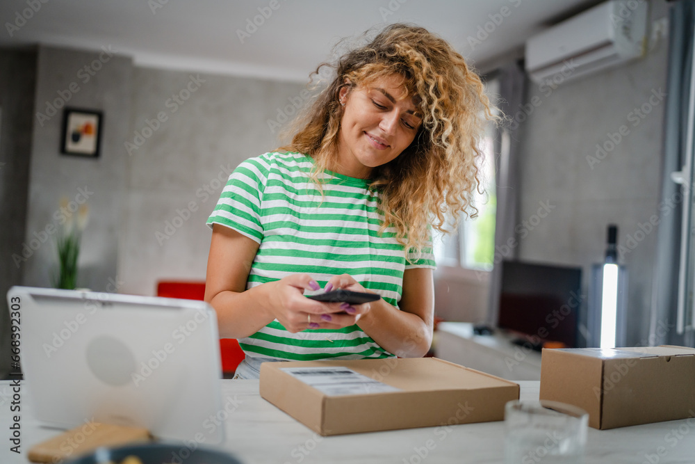 one woman checking box of received package or product at home one woman checking box of received package or product at home