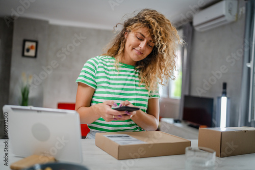 one woman checking box of received package or product at home