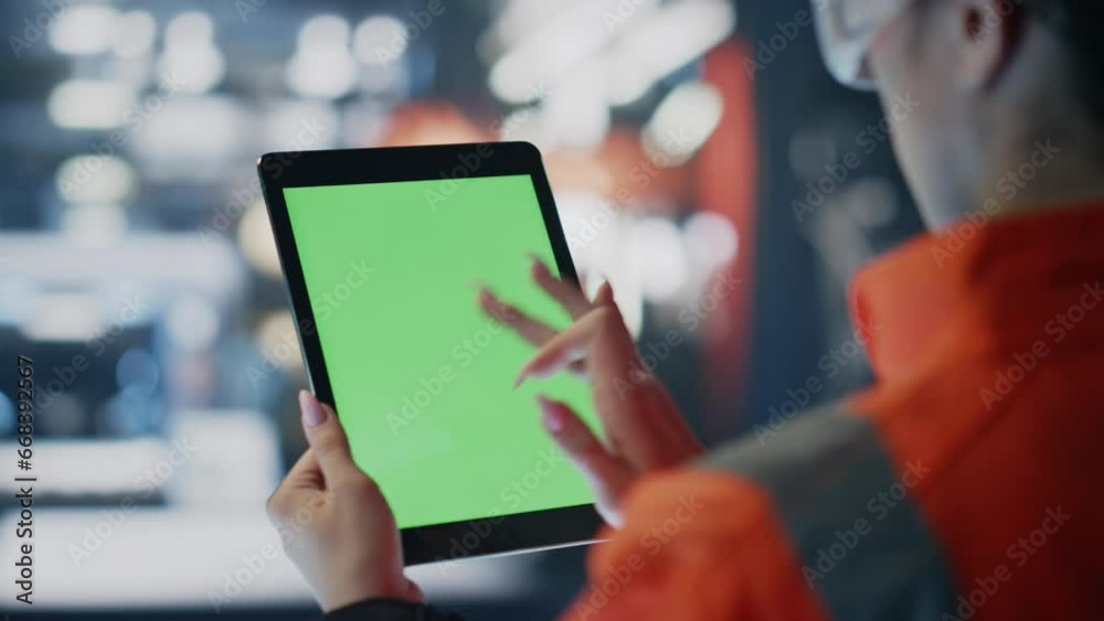 Engineer hands scrolling green screen tablet at production factory close up.