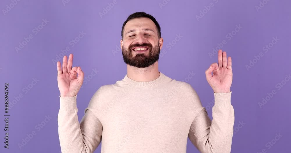Keep calm down, relax, inner balance. Young caucasian man with mudra gesture, eyes closed, meditating on purple background. Keep calm down, relax, inner balance. Young caucasian man with mudra gesture, eyes closed, meditating on purple background.