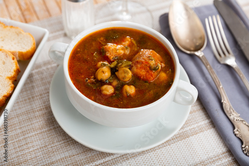 Cocido Andaluz - traditional Spanish dish, thick and hearty stew made with meat, lard, sausages, legumes and vegetables, cooked over low heat