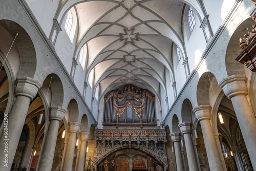 Ceiling and rear part with organ in a light Romanesque three-nave columned basilica. Minster (Münster Unserer Lieben Frau Konstanz), Lake Constance (Bodensee), Baden-Württemberg, Germany.