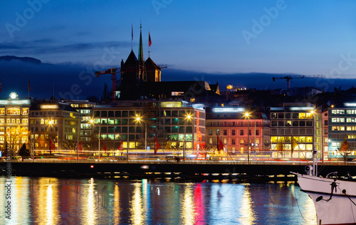 Cityscape of Geneva city in the evening viewed behind Geneva lake in Switzerland