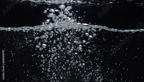 soda water bubbles splashing underwater against black background cola liquid texture that fizzing and floating up to surface like a explosion in under water for refreshing carbonate drink concept photo