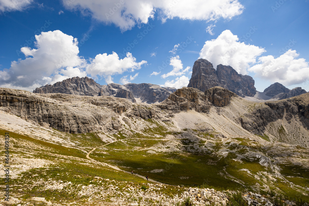 Breathtaking Dolomite Alps rise majestically, showcasing their rugged beauty under pristine sky.