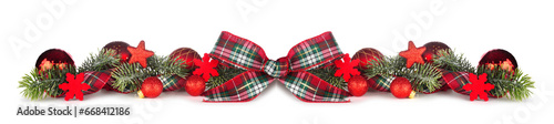 Christmas border with plaid ribbon, red ornaments and branches isolated on a white background