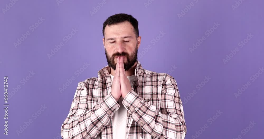 Portrait of bearded man praying, begging, holding hands together with hope face expression isolated on purple background. Portrait of bearded man praying, begging, holding hands together with hope face expression isolated on purple background.