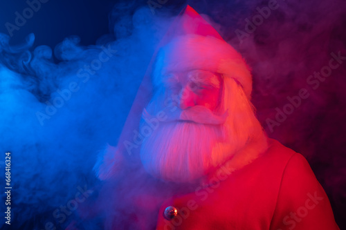 Santa Claus portrait in blue red neon light and smoke. 